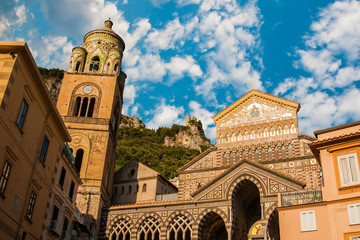 The Amalfi Duomo during sunset under puffy clouds, Italy