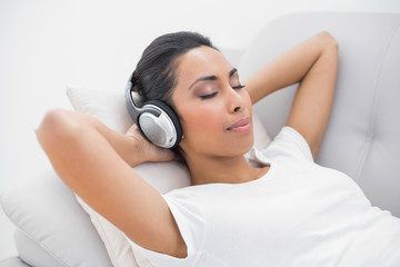 Cute relaxing woman listening to music