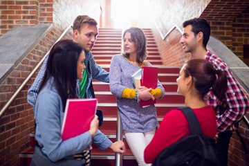 College students convering on stairs in college