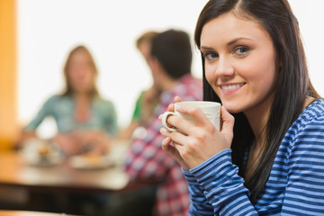 Portrait of a smiling female having coffee at  coffee shop