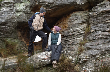 Young couple on rock while on a hike
