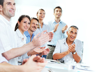 Business people clapping in a meeting