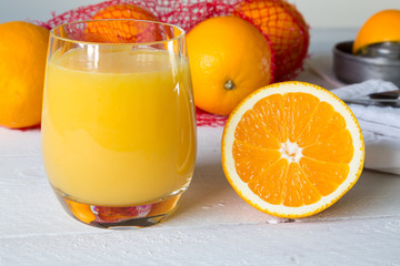 Orangensaft im Glas und Orange
