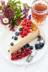 Piece of homemade honey cake decorated with fresh berries
