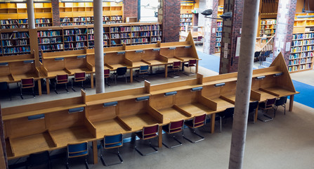 Empty seats and bookshelves at college library