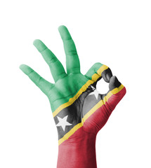 Hand making Ok sign, Saint Kitts and Nevis flag painted