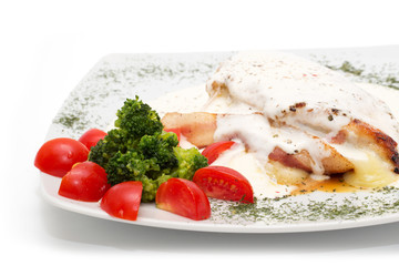 Chicken with gorgonzola, vegetables and bread on the plate