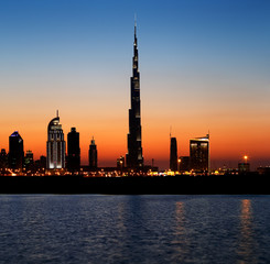 Naklejka premium Dubai skyline at dusk seen from the Gulf Coast