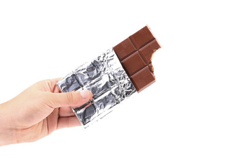 Hand holds bar of chocolate in foil
