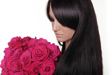 Healthy long hair. Brunette woman with fringe holding pink bouqu