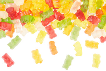 Gummy bears candies falling border on white, clipping path