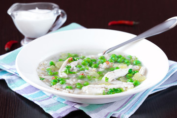 Chicken soup with green peas, pearl barley, chili pepper, food