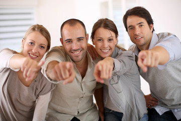 Business people pointing at camera