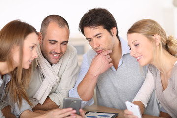 Business meeting around table with electronic devices