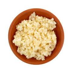 Minced garlic in a small red clay bowl