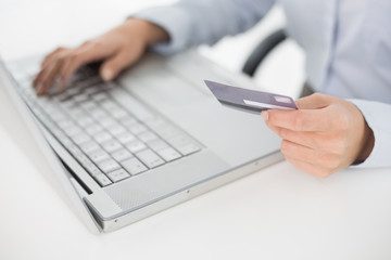 Close-up mid section of a woman doing online shopping
