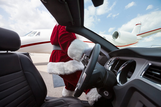 Santa Driving Convertible At Airport Terminal