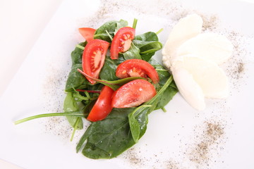 Caprese salad with spinach and rucola leaves