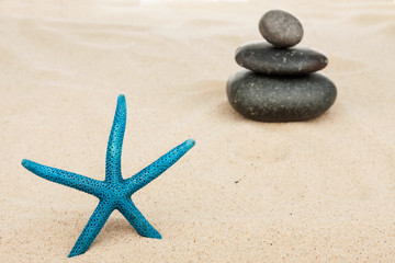 Fototapeta na wymiar Starfish and the pyramid on the sand