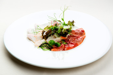 Cold appetizer, slices of trout and herring