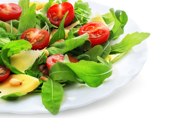 Salad with ruccola, pine nuts, cheese and baby tomatoes