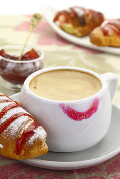 1874.	Cup of coffee with lipstick mark and croissant with strawb