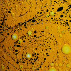 oil water emulsion golden color with black spots