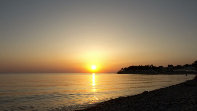 Sunset over water. Time Lapse.