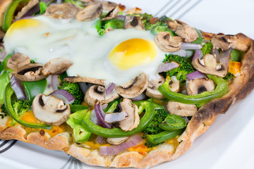 Fresh, hot baked Vegetarian flatbread pizza with 2 eggs sunny si