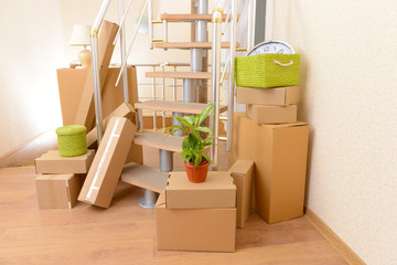 Stack of cartons near stairs: moving house concept