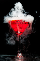red cocktail with ice vapor