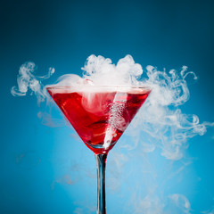 red cocktail with ice vapor