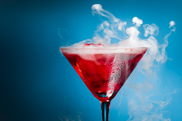 red cocktail with ice vapor