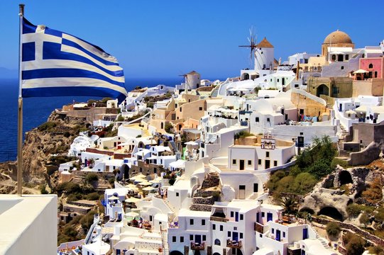 Fototapeta Beautiful view of Santorini with Greek flag