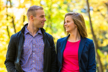 Fototapeta premium Urban leisure - woman and man walking in park