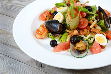 Salad with seafood with a squid, a tuna fillet, meat of mussels