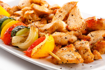 Grilled meat and vegetables on white background