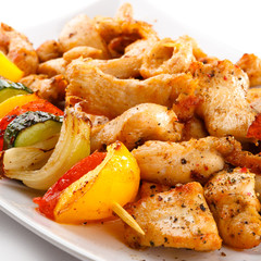 Grilled meat and vegetables on white background