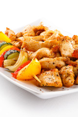 Grilled meat and vegetables on white background