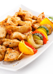 Grilled meat and vegetables on white background