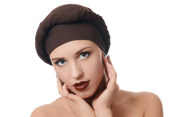The beautiful woman in a turban with a creative make-up
