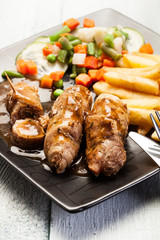 Beef rolls and vegetables