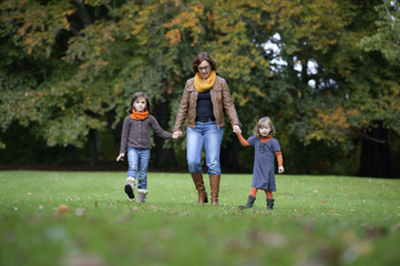 mother and daughters walking a the park