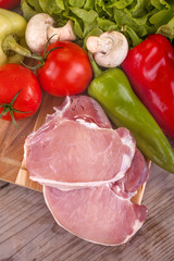 pork chops with salad and vegetables