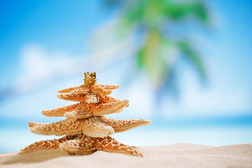 starfish christmas tree on beach with seascape background