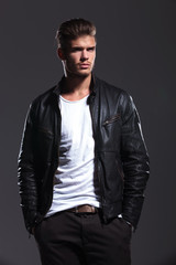 Fototapeta premium young man in leather jacket is looking away