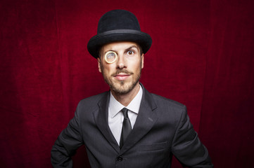 young gentleman witha condom monocle - obrazy, fototapety, plakaty