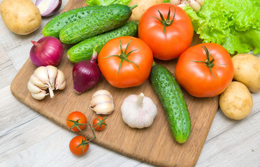 fresh vegetables on a cutting board on a wooden table