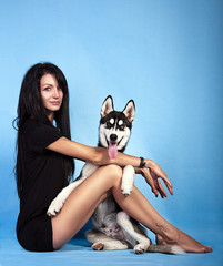 beautiful girl in the studio with a dog