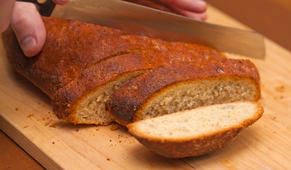 cutting freshly made bread